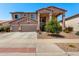 Inviting two-story home featuring a three-car garage and well-manicured front yard landscaping at 15792 W Desert Mirage Dr, Surprise, AZ 85379