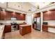 Modern kitchen featuring stainless steel appliances, a kitchen island, and ample cabinet space at 15792 W Desert Mirage Dr, Surprise, AZ 85379