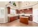 Well-equipped kitchen with stainless steel appliances, wood cabinetry, and modern lighting at 15792 W Desert Mirage Dr, Surprise, AZ 85379