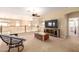 Upstairs sitting room with casual furniture, ceiling fan and large window providing natural light at 15792 W Desert Mirage Dr, Surprise, AZ 85379