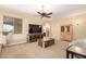 Upstairs sitting room with casual furniture, ceiling fan and large window providing natural light at 15792 W Desert Mirage Dr, Surprise, AZ 85379