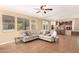 Open living room with tile floors, a ceiling fan, and direct view to the kitchen at 15792 W Desert Mirage Dr, Surprise, AZ 85379