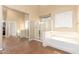 Bright main bathroom featuring a separate tub, shower, and a walk-in closet at 15792 W Desert Mirage Dr, Surprise, AZ 85379