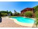 Beautiful backyard pool surrounded by lush landscaping and a well-maintained patio area at 15792 W Desert Mirage Dr, Surprise, AZ 85379