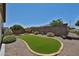 Landscaped backyard featuring turf, desert landscape, and privacy wall at 17082 S 182Nd Ave, Goodyear, AZ 85338