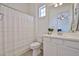 Well-lit bathroom with a white vanity, clean fixtures, a toilet, and a shower with a curtain, offering functionality at 17082 S 182Nd Ave, Goodyear, AZ 85338