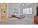Serene bedroom featuring soft carpet, plantation shutters, and a ceiling fan at 17082 S 182Nd Ave, Goodyear, AZ 85338