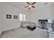 Bright bedroom with large window, ceiling fan, light-colored walls, and comfortable couch, ideal for relaxation at 17082 S 182Nd Ave, Goodyear, AZ 85338