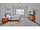 Calm bedroom features neutral carpet, shutters, ceiling fan and wood furniture at 17082 S 182Nd Ave, Goodyear, AZ 85338