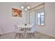 Cozy dining area features a modern table and chairs, complemented by natural light from the nearby window at 17082 S 182Nd Ave, Goodyear, AZ 85338