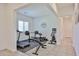 Home gym featuring a treadmill, weightlifting equipment, and fitness bike at 17082 S 182Nd Ave, Goodyear, AZ 85338