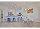 Bright kitchen features stainless steel appliances, granite countertops, white cabinetry, and an adjacent dining area at 17082 S 182Nd Ave, Goodyear, AZ 85338