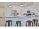 Bright kitchen boasts granite countertops, stainless steel appliances, and seating at the breakfast bar at 17082 S 182Nd Ave, Goodyear, AZ 85338