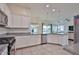 Modern kitchen featuring white cabinets, granite countertops, stainless steel appliances, and open layout to the living areas at 17082 S 182Nd Ave, Goodyear, AZ 85338