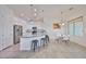 Spacious kitchen boasts stainless steel appliances, white cabinets, granite countertops, and an open layout to the dining area at 17082 S 182Nd Ave, Goodyear, AZ 85338