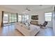Bright living room featuring a ceiling fan, neutral furniture, and sliding glass doors at 17082 S 182Nd Ave, Goodyear, AZ 85338