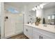 Modern bathroom with double vanity, quartz countertop and a glass-enclosed shower at 17962 W Sand Hills Rd, Surprise, AZ 85387