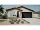 Charming single-story home featuring a desert-landscaped front yard and an attached two-car garage at 17962 W Sand Hills Rd, Surprise, AZ 85387
