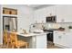 Stylish kitchen with white cabinets, stainless steel appliances, and an island with bar seating at 17962 W Sand Hills Rd, Surprise, AZ 85387