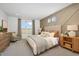 Serene bedroom featuring neutral tones, modern wall accents, and plenty of natural light at 17962 W Sand Hills Rd, Surprise, AZ 85387