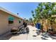 View of the home's backyard featuring a motorcycle, concrete patio, and shade tree at 1804 S Standage Cir, Mesa, AZ 85202