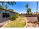 Backyard with mature landscaping and a block fence at 1804 S Standage Cir, Mesa, AZ 85202