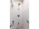 Bathroom features white tiled shower with gray tile accents, grab bars and shower head at 1804 S Standage Cir, Mesa, AZ 85202