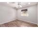 Bright bedroom with wood-look tile flooring and a window at 1804 S Standage Cir, Mesa, AZ 85202