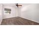Bedroom features neutral carpet, ceiling fan, and view to exterior at 1804 S Standage Cir, Mesa, AZ 85202
