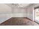 Bedroom features neutral carpet, ceiling fan, wainscotting, and view to exterior at 1804 S Standage Cir, Mesa, AZ 85202