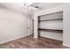 Bedroom with wood-look tile floors and built-in shelving at 1804 S Standage Cir, Mesa, AZ 85202