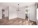 Light and bright dining room with modern chandelier and wood-look floors at 1804 S Standage Cir, Mesa, AZ 85202