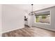 Light and bright dining room with modern chandelier and wood-look floors at 1804 S Standage Cir, Mesa, AZ 85202