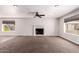 Spacious living room featuring plush carpeting, a ceiling fan and a fireplace at 1804 S Standage Cir, Mesa, AZ 85202