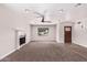 Spacious living room featuring plush carpeting, a fireplace and a ceiling fan at 1804 S Standage Cir, Mesa, AZ 85202