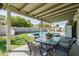 Beautiful backyard featuring a covered patio, sparkling pool, lush lawn, and privacy fence at 18818 N 12Th Ave, Phoenix, AZ 85027