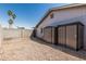 Enclosed gravel backyard with tall cinder block fence and outdoor storage sheds at 18818 N 12Th Ave, Phoenix, AZ 85027