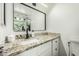 Bathroom vanity featuring a white countertop, dark faucet, and a framed mirror at 18818 N 12Th Ave, Phoenix, AZ 85027