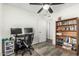Office/bedroom featuring gray wood flooring, a ceiling fan, and a wood bookcase for storage at 18818 N 12Th Ave, Phoenix, AZ 85027