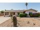 Charming single-story home featuring desert landscaping, a covered carport, and solar panels on the roof at 18818 N 12Th Ave, Phoenix, AZ 85027