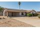 A single-story home with carport and drought-resistant landscaping, showcasing solar panels on the roof at 18818 N 12Th Ave, Phoenix, AZ 85027