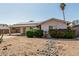 Single-story home featuring desert landscaping with decorative rock features and colorful shrubs at 18818 N 12Th Ave, Phoenix, AZ 85027