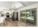 Bright kitchen featuring white cabinets and a view of the pool through sliding glass doors at 18818 N 12Th Ave, Phoenix, AZ 85027