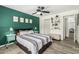Bedroom with wooden floors, a queen bed, and an accent wall with framed art at 18818 N 12Th Ave, Phoenix, AZ 85027