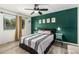 Well-lit bedroom with a queen size bed, green accent wall, and side tables at 18818 N 12Th Ave, Phoenix, AZ 85027