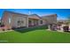 Spacious backyard with artificial turf, covered patio and outdoor seating, perfect for entertaining and enjoying the outdoors at 19910 W Mulberry Dr, Buckeye, AZ 85396