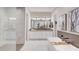 Luxurious bathroom with a soaking tub, a separate tiled shower, and elegant vanity, offering a spa-like experience at 19910 W Mulberry Dr, Buckeye, AZ 85396