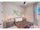 Charming bedroom features a unique mural, side tables with lamps, and natural light at 19910 W Mulberry Dr, Buckeye, AZ 85396