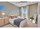 Comfortable bedroom with neutral tones, modern decor, and a bright window at 19910 W Mulberry Dr, Buckeye, AZ 85396