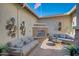 Inviting outdoor courtyard features a stone fireplace, comfortable seating, decorative wall art and is perfect for relaxation at 19910 W Mulberry Dr, Buckeye, AZ 85396